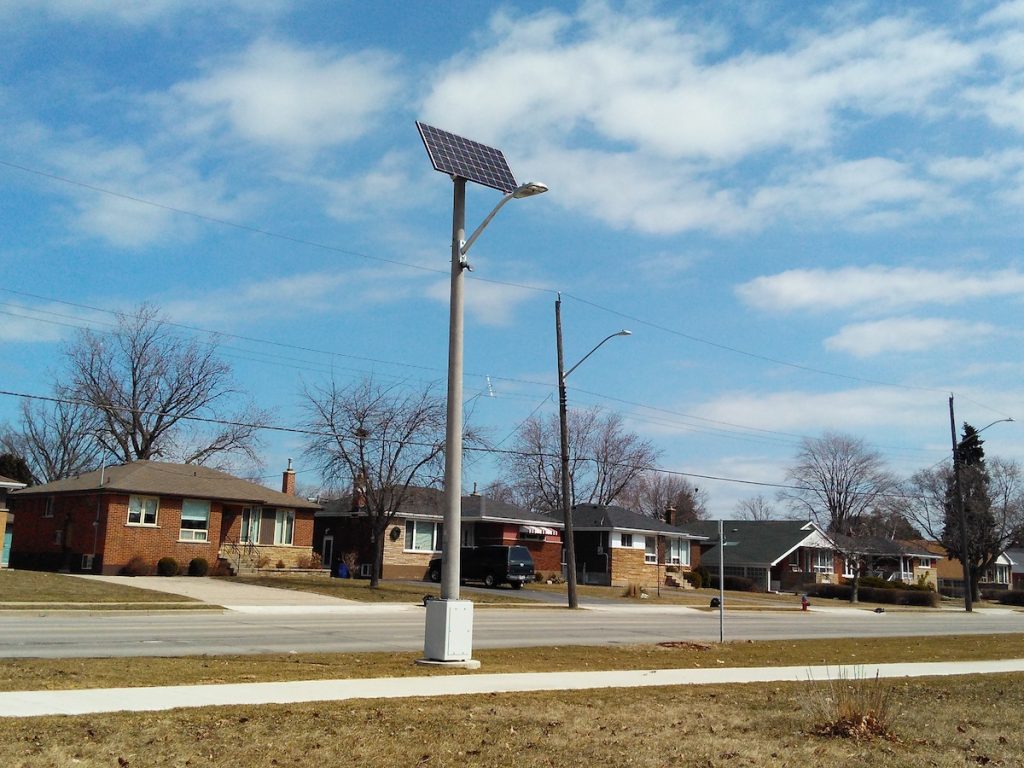 Clear Blue off grid light pole in suburban area