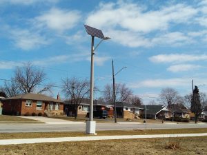 Clear Blue off grid light pole in suburban area