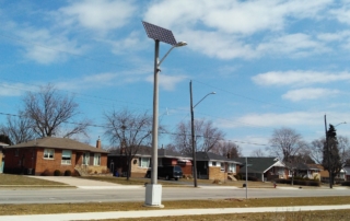 Clear Blue off grid light pole in suburban area